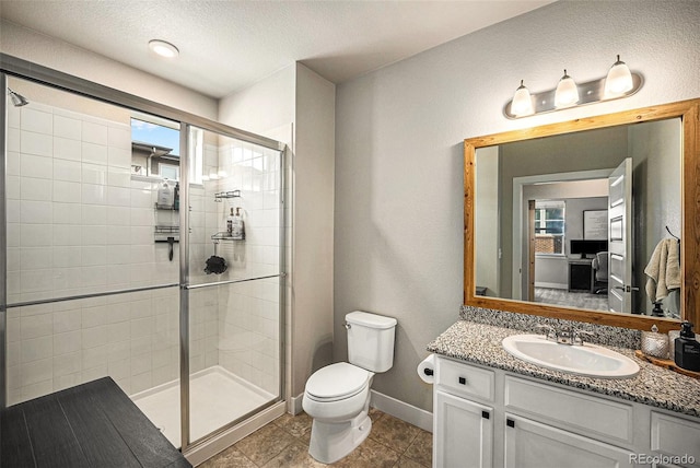 15274 W 64th Ln Unit 206, Arvada, CO 80007 - full bath with tile patterned flooring, vanity, toilet, a textured ceiling, and a stall shower