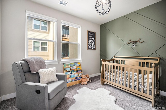 15274 W 64th Ln Unit 206, Arvada, CO 80007 - carpeted bedroom with baseboards, visible vents, and a crib