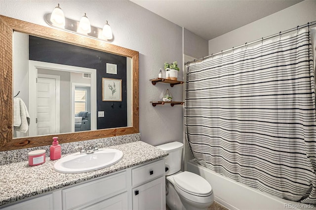15274 W 64th Ln Unit 206, Arvada, CO 80007 - full bath with vanity, shower / tub combo with curtain, a textured wall, and toilet
