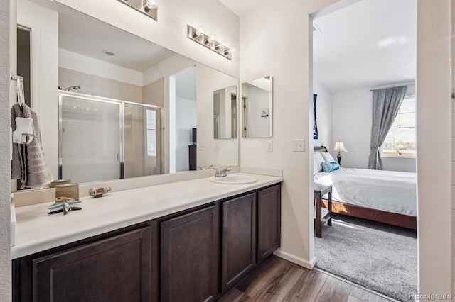 95 S Edge Cliff St, Castle Rock, CO 80104 - ensuite bathroom featuring wood finished floors, vanity, ensuite bath, baseboards, and a stall shower