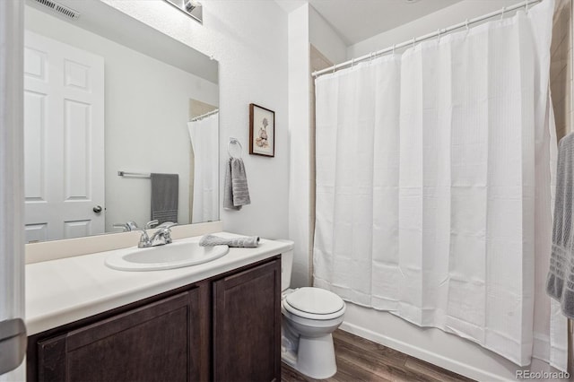 95 S Edge Cliff St, Castle Rock, CO 80104 - bathroom featuring wood finished floors, vanity, shower / bathtub combination with curtain, toilet, and visible vents