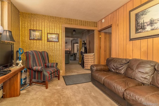 living room featuring light carpet and wood walls