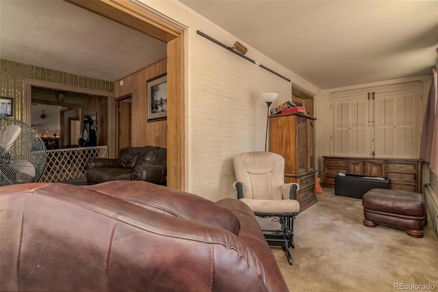 living room featuring wooden walls and light colored carpet