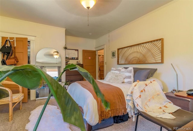 bedroom with carpet floors, ceiling fan, and ornamental molding