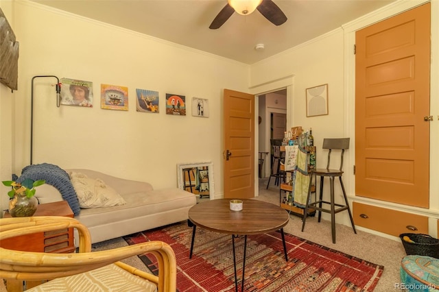 carpeted living room featuring ceiling fan and crown molding