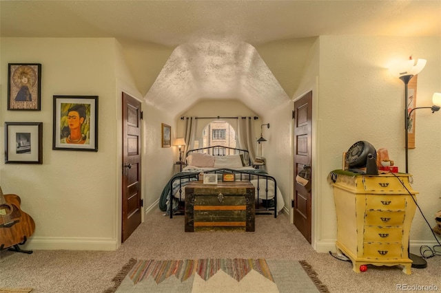 carpeted bedroom with lofted ceiling and a textured ceiling