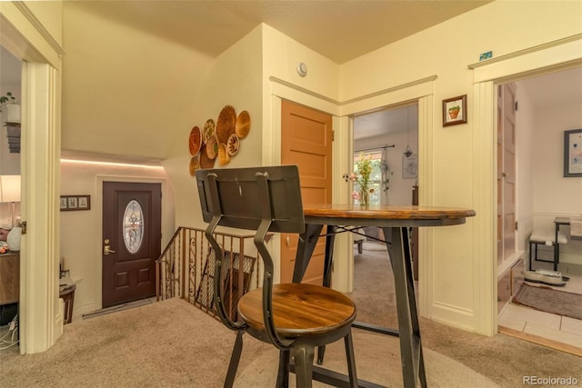 foyer featuring light colored carpet