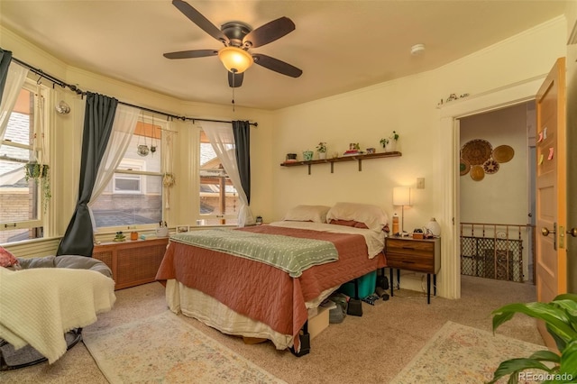 carpeted bedroom featuring multiple windows and ceiling fan