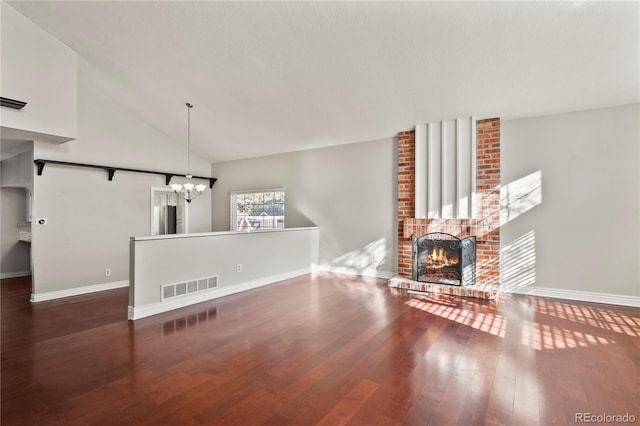 unfurnished living room featuring an inviting chandelier, dark wood-type flooring, a fireplace, and high vaulted ceiling