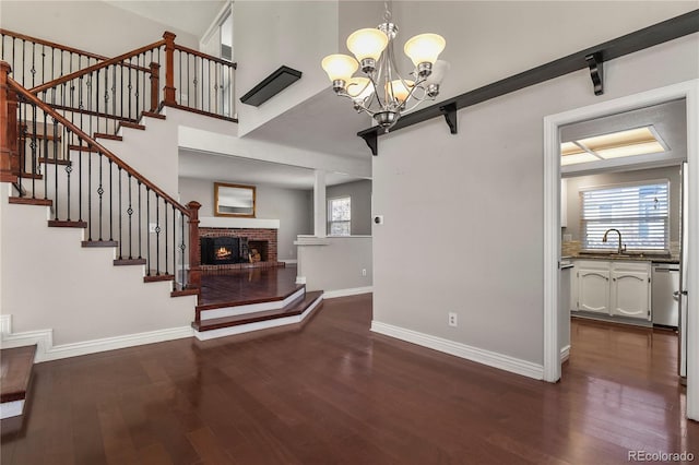 interior space with a barn door, dark wood-type flooring, sink, and plenty of natural light