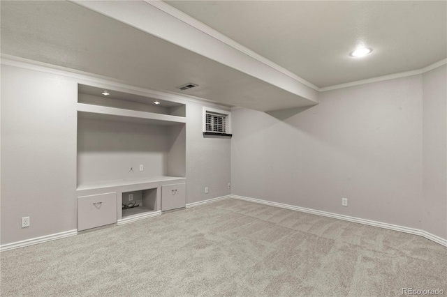 basement with carpet floors and ornamental molding