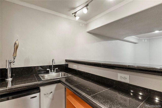 kitchen with sink, crown molding, track lighting, and stainless steel dishwasher