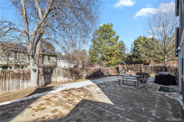 view of patio / terrace with a grill and a playground