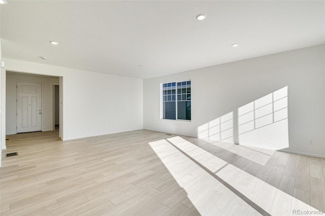 unfurnished room with light wood-type flooring