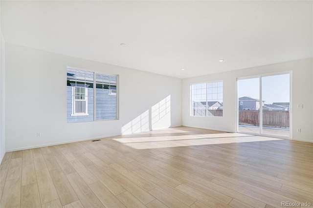 spare room with light hardwood / wood-style flooring