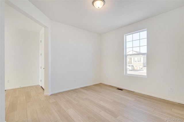 empty room with light hardwood / wood-style floors