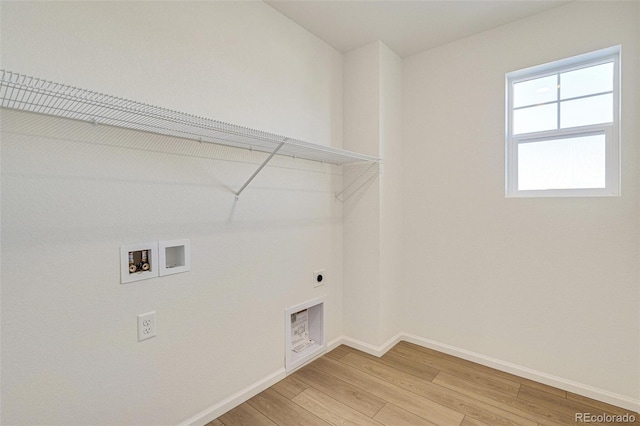 washroom with hardwood / wood-style flooring, hookup for an electric dryer, and washer hookup