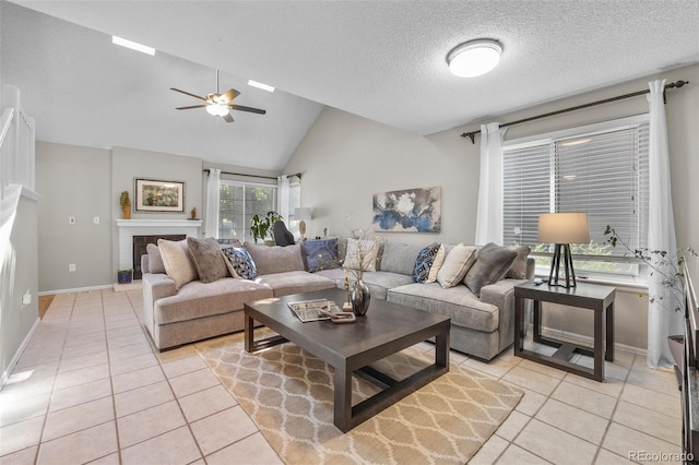 944 E Lily Ct, Highlands Ranch, CO 80126 - living area with light tile patterned flooring, ceiling fan, a tile fireplace, a textured ceiling, and high vaulted ceiling