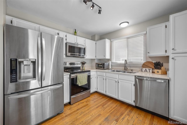 944 E Lily Ct, Highlands Ranch, CO 80126 - kitchen featuring appliances with stainless steel finishes, white cabinetry, and light countertops