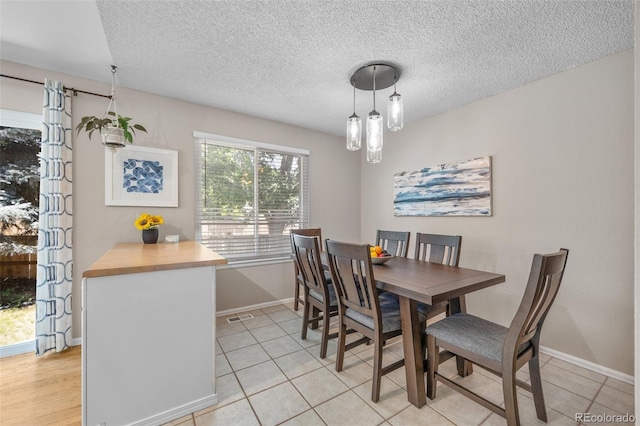 944 E Lily Ct, Highlands Ranch, CO 80126 - dining space with light tile patterned floors and a textured ceiling