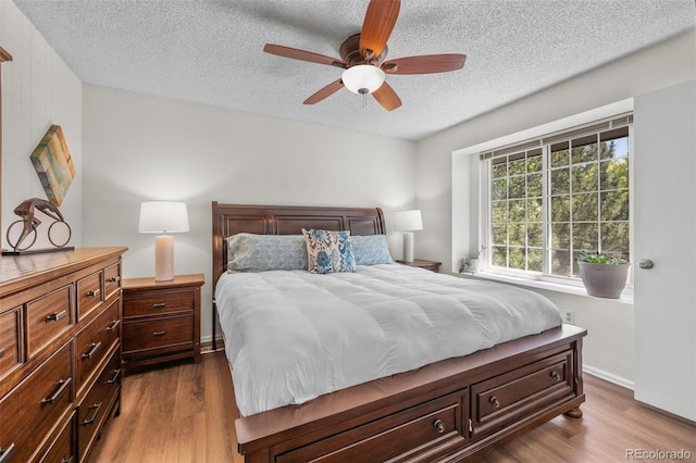 944 E Lily Ct, Highlands Ranch, CO 80126 - bedroom featuring dark wood finished floors, a textured ceiling, and ceiling fan