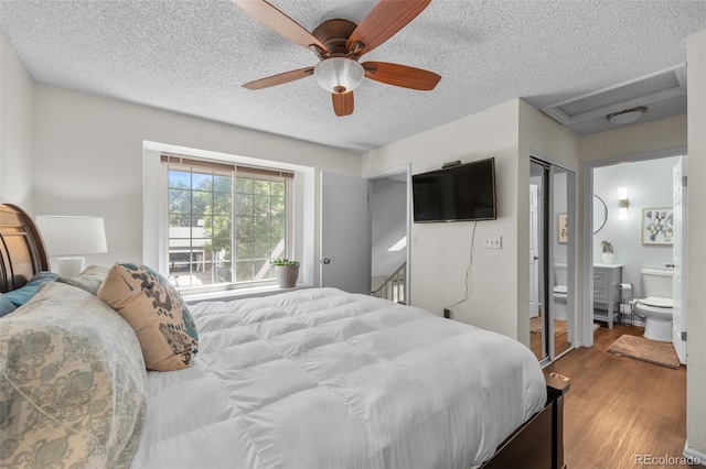 944 E Lily Ct, Highlands Ranch, CO 80126 - bedroom featuring wood finished floors, a textured ceiling, attic access, a ceiling fan, and ensuite bathroom