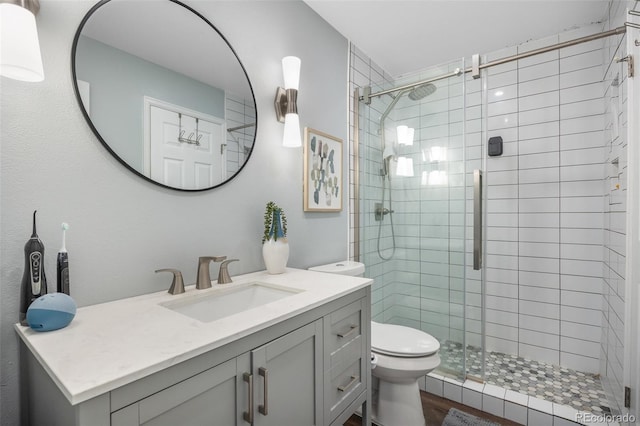 944 E Lily Ct, Highlands Ranch, CO 80126 - bathroom featuring a shower stall, vanity, and wood finished floors