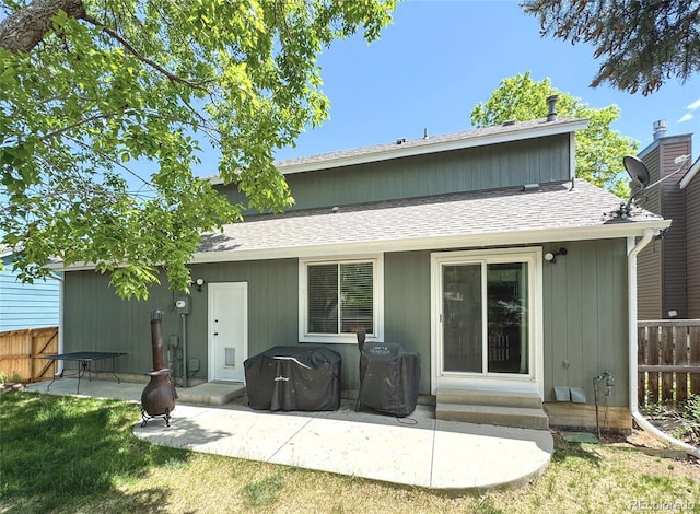 944 E Lily Ct, Highlands Ranch, CO 80126 - back of property featuring a shingled roof, a patio area, and entry steps
