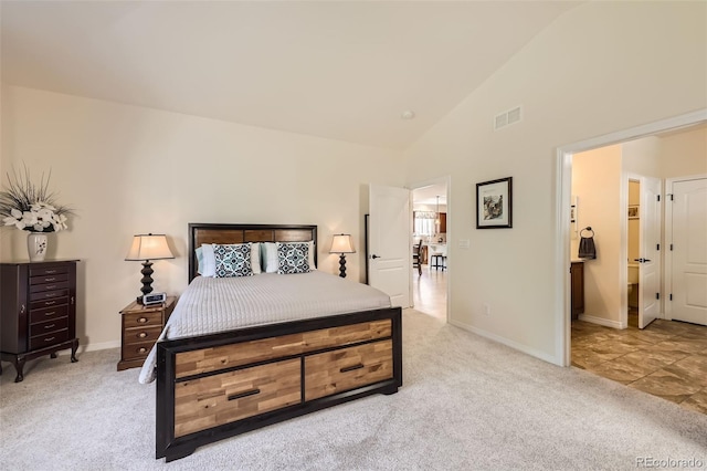 carpeted bedroom featuring high vaulted ceiling and a walk in closet