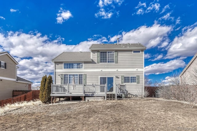 back of property with a fenced backyard and a wooden deck