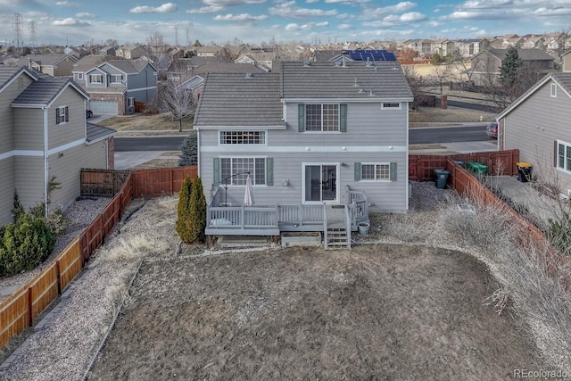 rear view of property with a residential view, a fenced backyard, and a deck