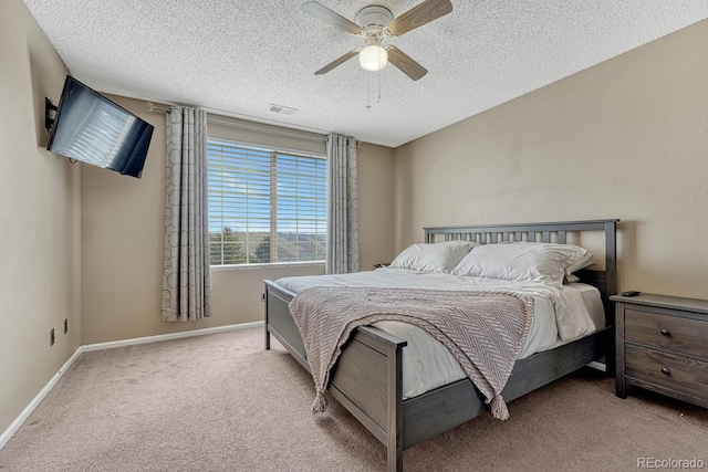 bedroom featuring carpet floors, a ceiling fan, a textured ceiling, and visible vents