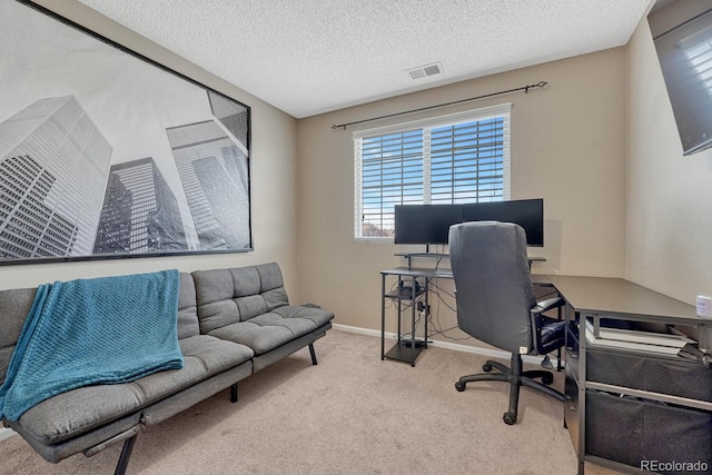 office space featuring baseboards, a textured ceiling, visible vents, and carpet