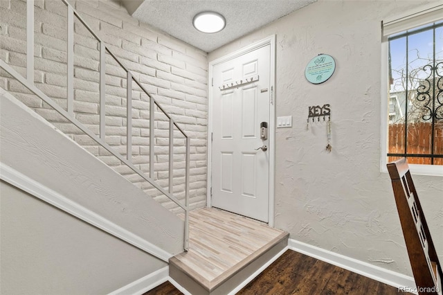 1060 S Parker Rd Unit 19, Denver, CO 80231 - foyer entrance featuring baseboards, wood finished floors, and a textured ceiling