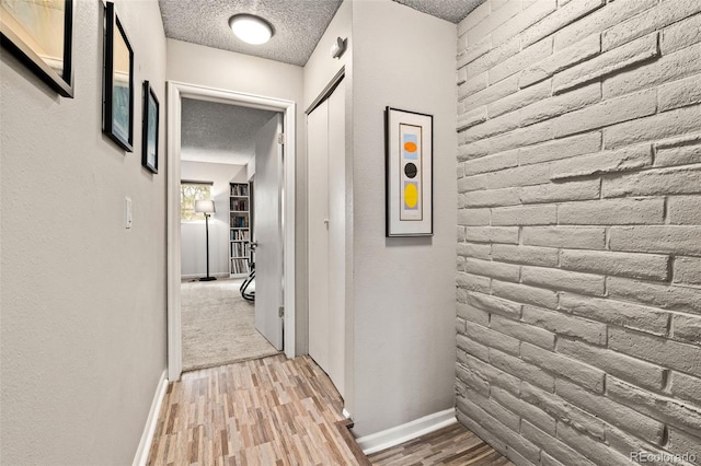 1060 S Parker Rd Unit 19, Denver, CO 80231 - hall with a textured ceiling, light wood finished floors, and baseboards