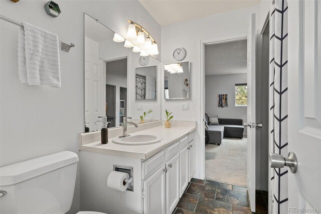 1060 S Parker Rd Unit 19, Denver, CO 80231 - bathroom featuring stone finish flooring, toilet, and vanity