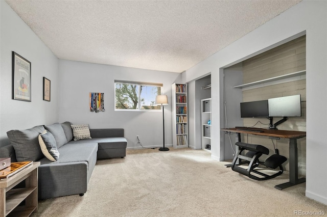 1060 S Parker Rd Unit 19, Denver, CO 80231 - carpeted living area featuring a textured ceiling, baseboards, and built in shelves