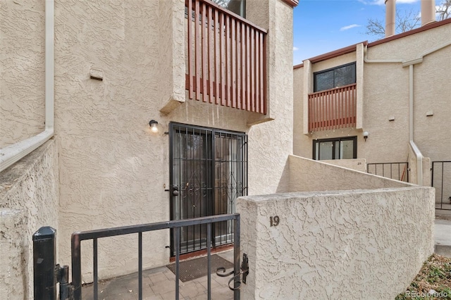 1060 S Parker Rd Unit 19, Denver, CO 80231 - doorway to property featuring stucco siding