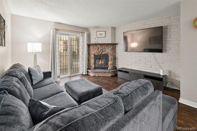 1060 S Parker Rd Unit 19, Denver, CO 80231 - living area featuring a stone fireplace, wood finished floors, a textured ceiling, and baseboards