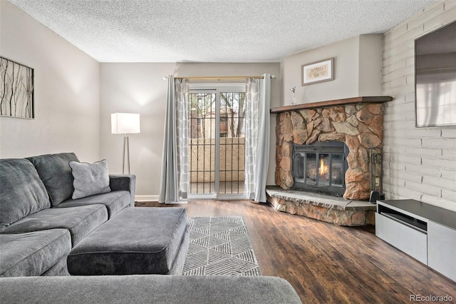 1060 S Parker Rd Unit 19, Denver, CO 80231 - living room with wood finished floors, a fireplace, and a textured ceiling