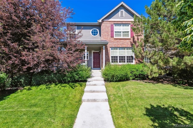 12427 James Ct, Broomfield, CO 80020 - traditional-style house featuring a front yard and brick siding