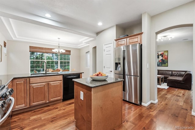 12427 James Ct, Broomfield, CO 80020 - kitchen with stainless steel appliances, a kitchen island, a chandelier, light wood-type flooring, and recessed lighting