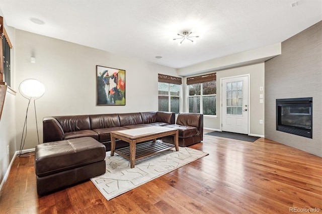 12427 James Ct, Broomfield, CO 80020 - living area with wood finished floors and a glass covered fireplace
