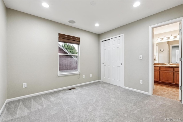 12427 James Ct, Broomfield, CO 80020 - unfurnished bedroom with light colored carpet, recessed lighting, a closet, and ensuite bath