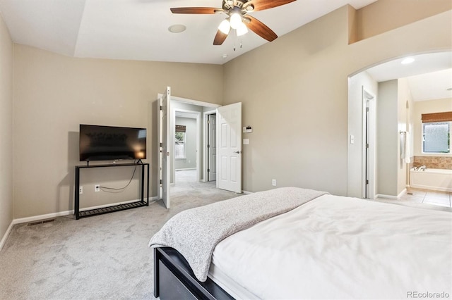 12427 James Ct, Broomfield, CO 80020 - bedroom with lofted ceiling, arched walkways, light colored carpet, connected bathroom, and ceiling fan