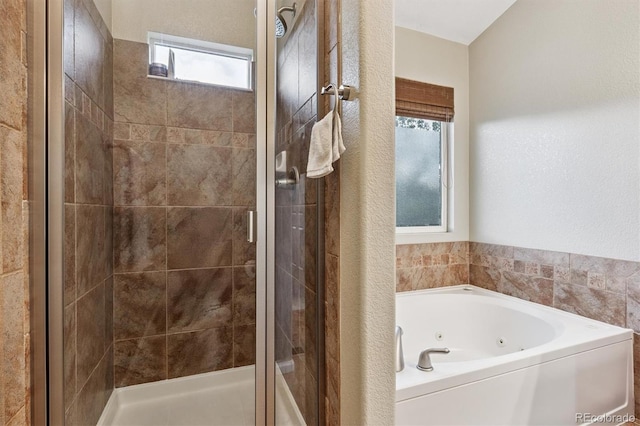 12427 James Ct, Broomfield, CO 80020 - full bathroom with a tub with jets and a shower stall