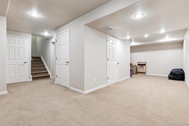12427 James Ct, Broomfield, CO 80020 - finished basement featuring a textured ceiling, carpet, stairs, and recessed lighting