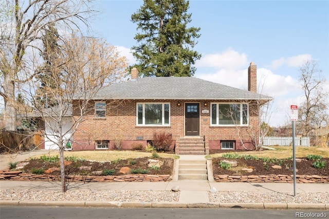 4121 W 49th Ave, Denver, CO 80212 - view of front of house featuring a chimney, brick siding, and fence