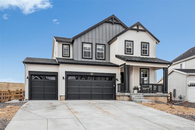 modern inspired farmhouse featuring covered porch, concrete driveway, board and batten siding, and a standing seam roof