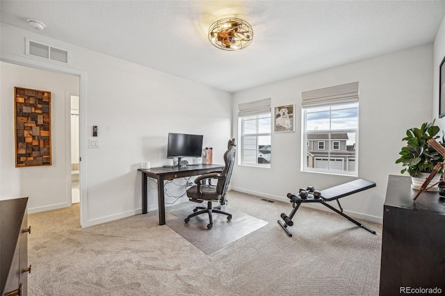 carpeted office with visible vents and baseboards